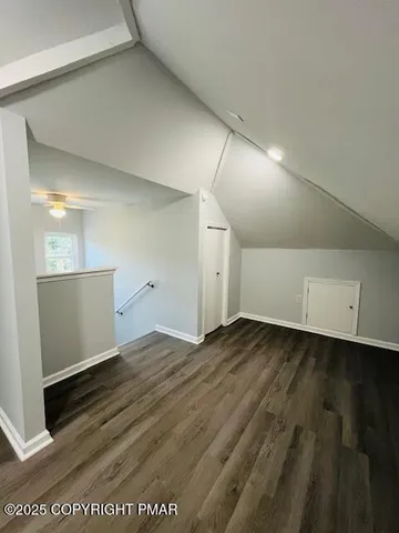 a view of an empty room and wooden floor