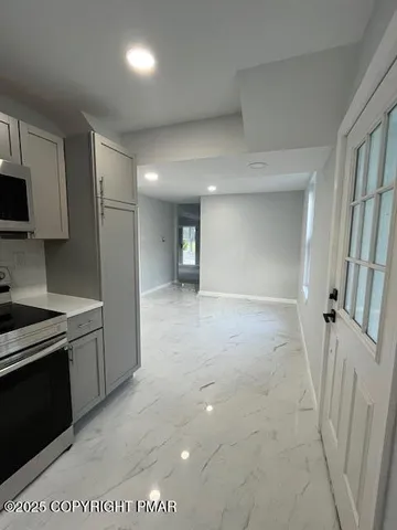 a view of a kitchen with a sink stove and cabinet