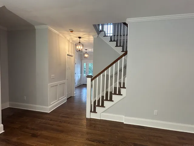 a view of entryway and hall with wooden floor