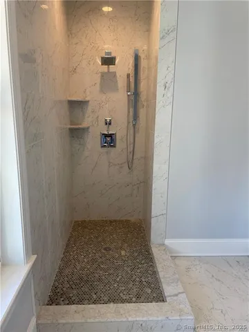 a bathroom with a toilet a sink and shower