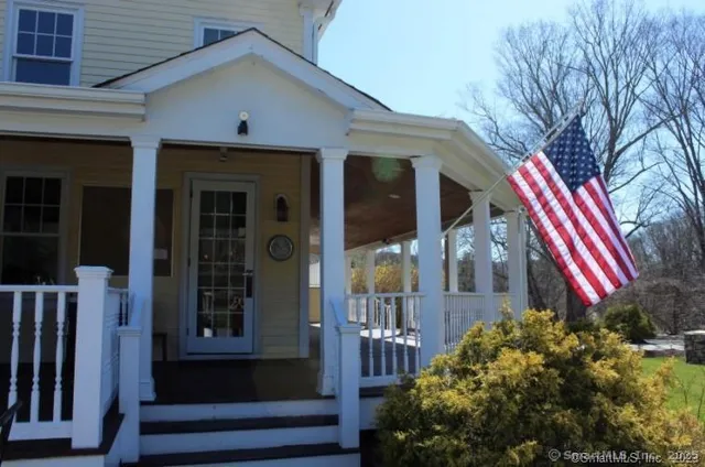 a view of front door and small yard