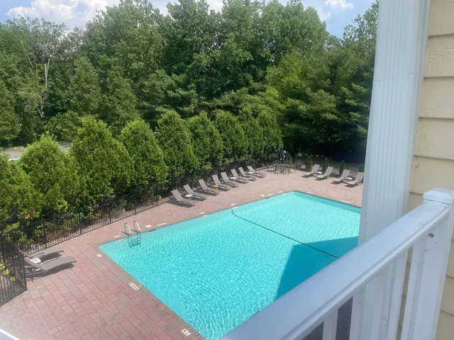 a view of a patio with dining table and chairs with a fire pit