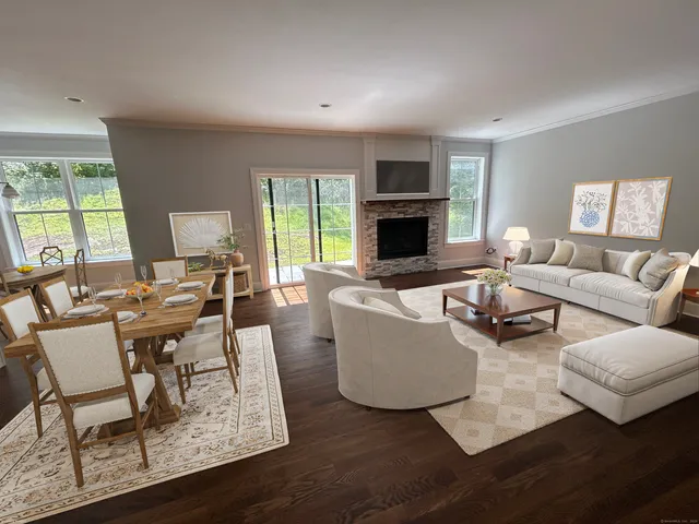 a living room with furniture fireplace and a table