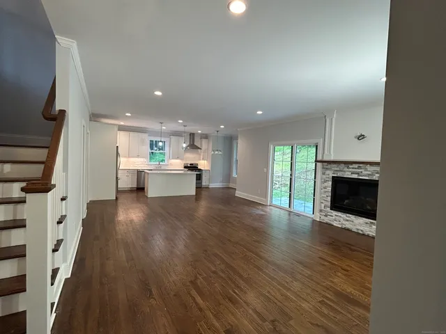 a view of kitchen and hall with wooden floor