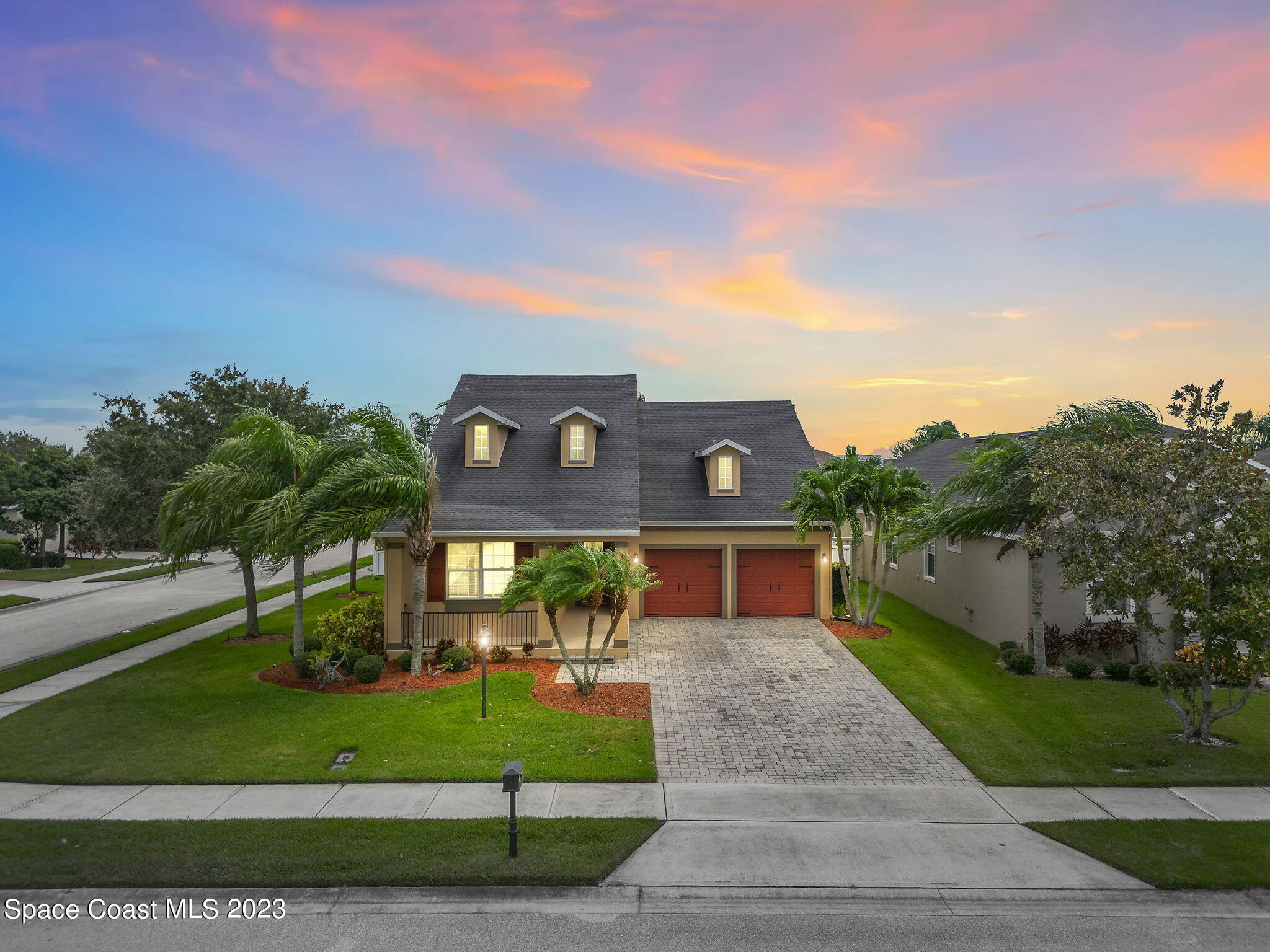 a front view of a house with a yard and a garage