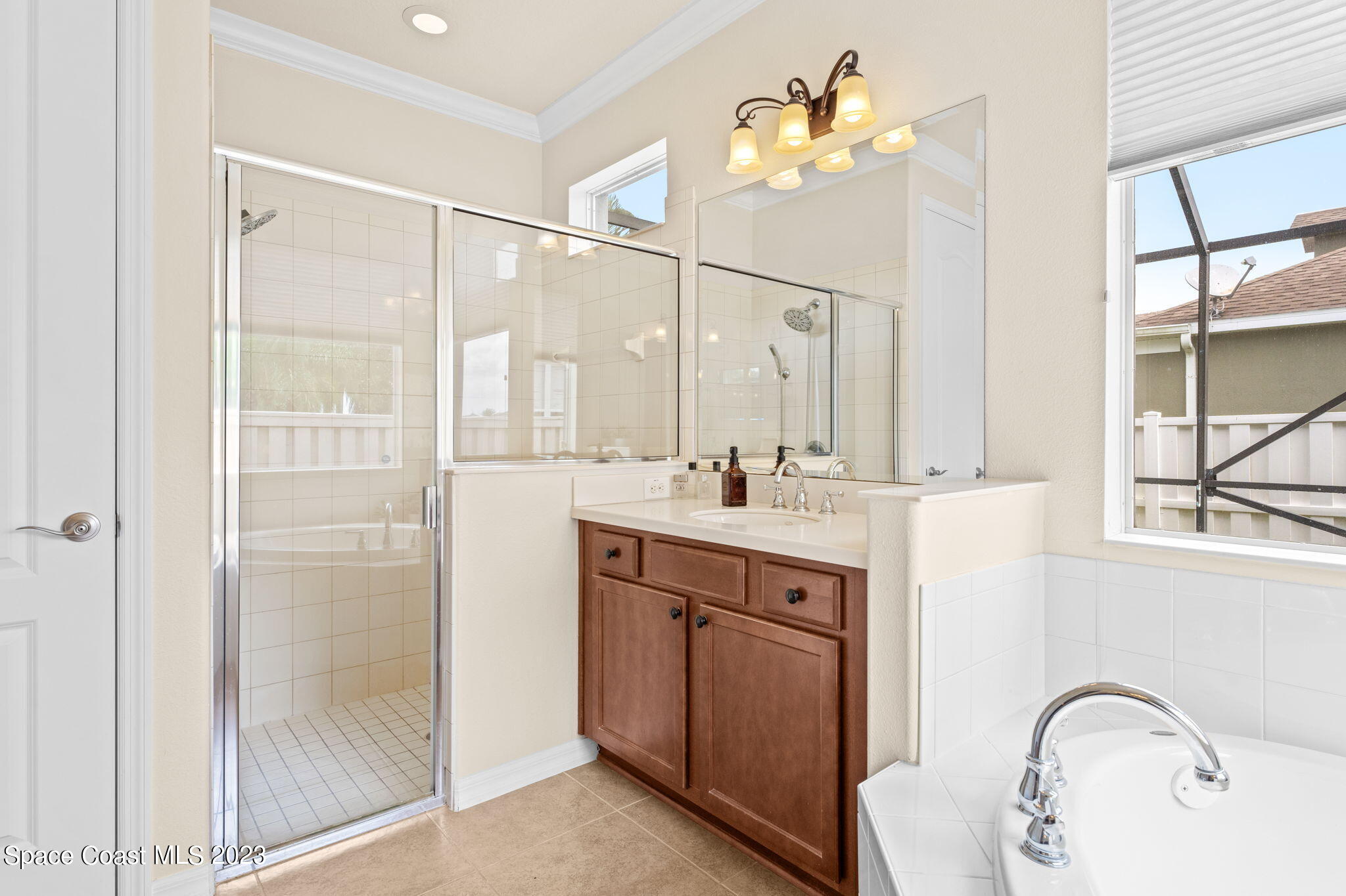 6265 Trieda Drive Melbourne, FL 32940 - Photo 11 of 26 a bathroom with a double vanity sink mirror and next to a window