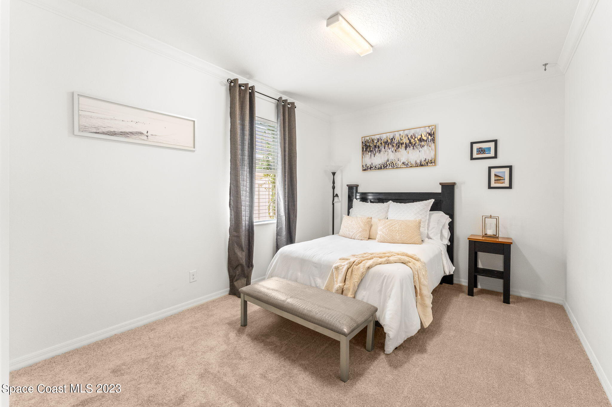 6265 Trieda Drive Melbourne, FL 32940 - Photo 12 of 26 a bedroom with a bed and a table