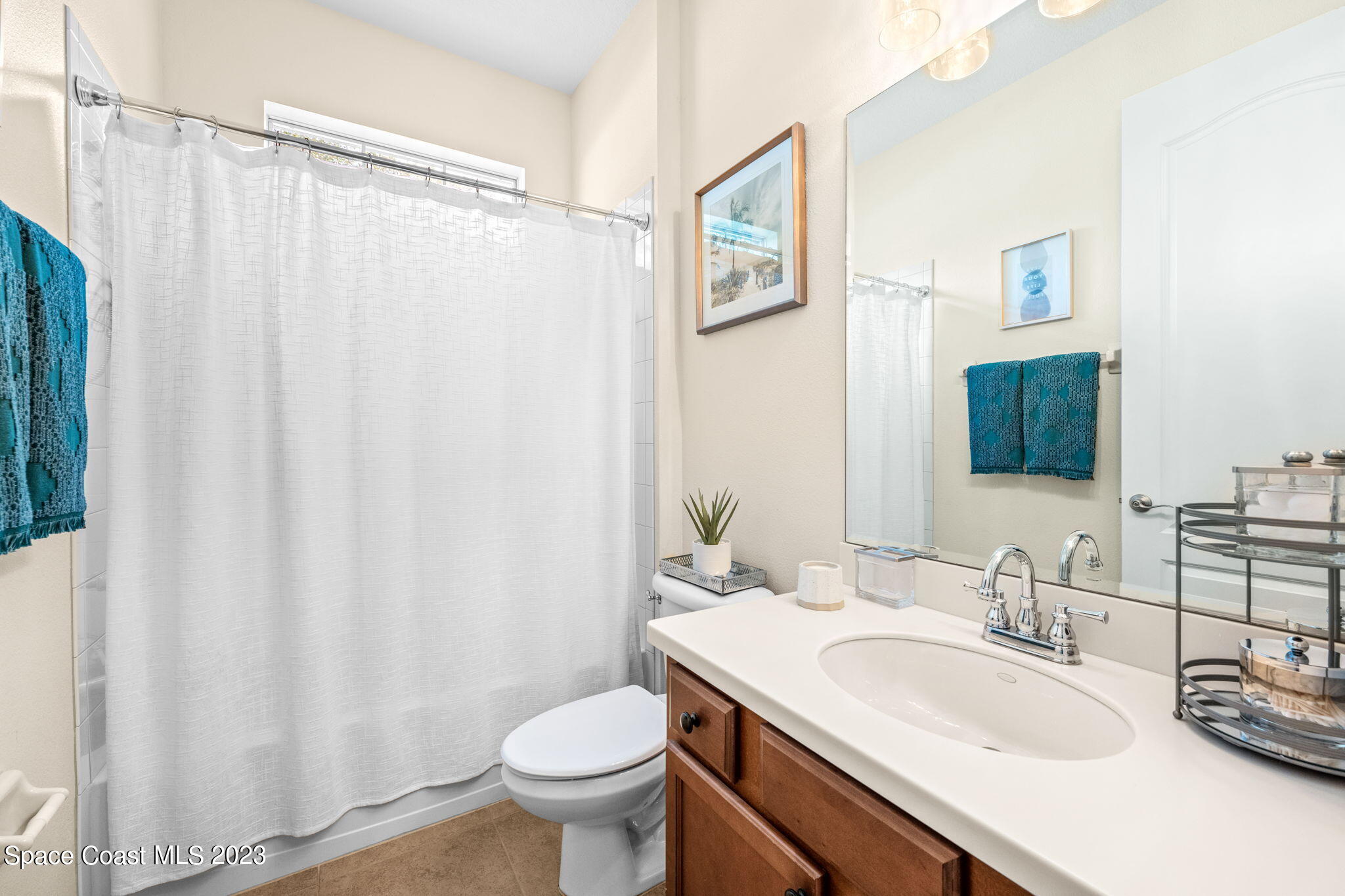 6265 Trieda Drive Melbourne, FL 32940 - Photo 13 of 26 a bathroom with a sink a toilet and a mirror