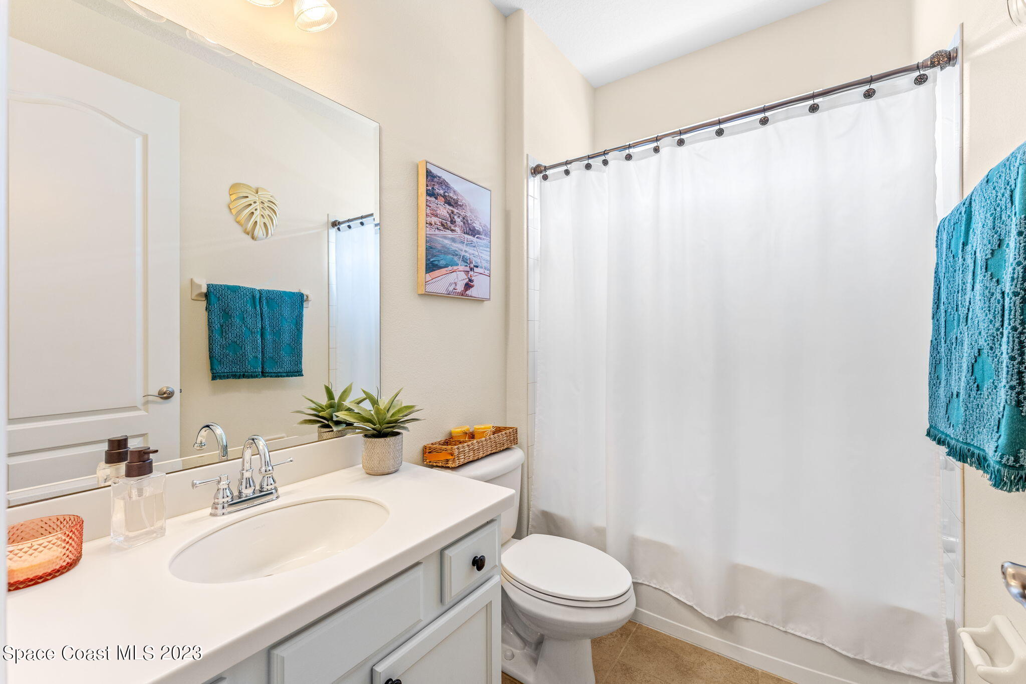 6265 Trieda Drive Melbourne, FL 32940 - Photo 15 of 26 a bathroom with a sink mirror vanity and toilet