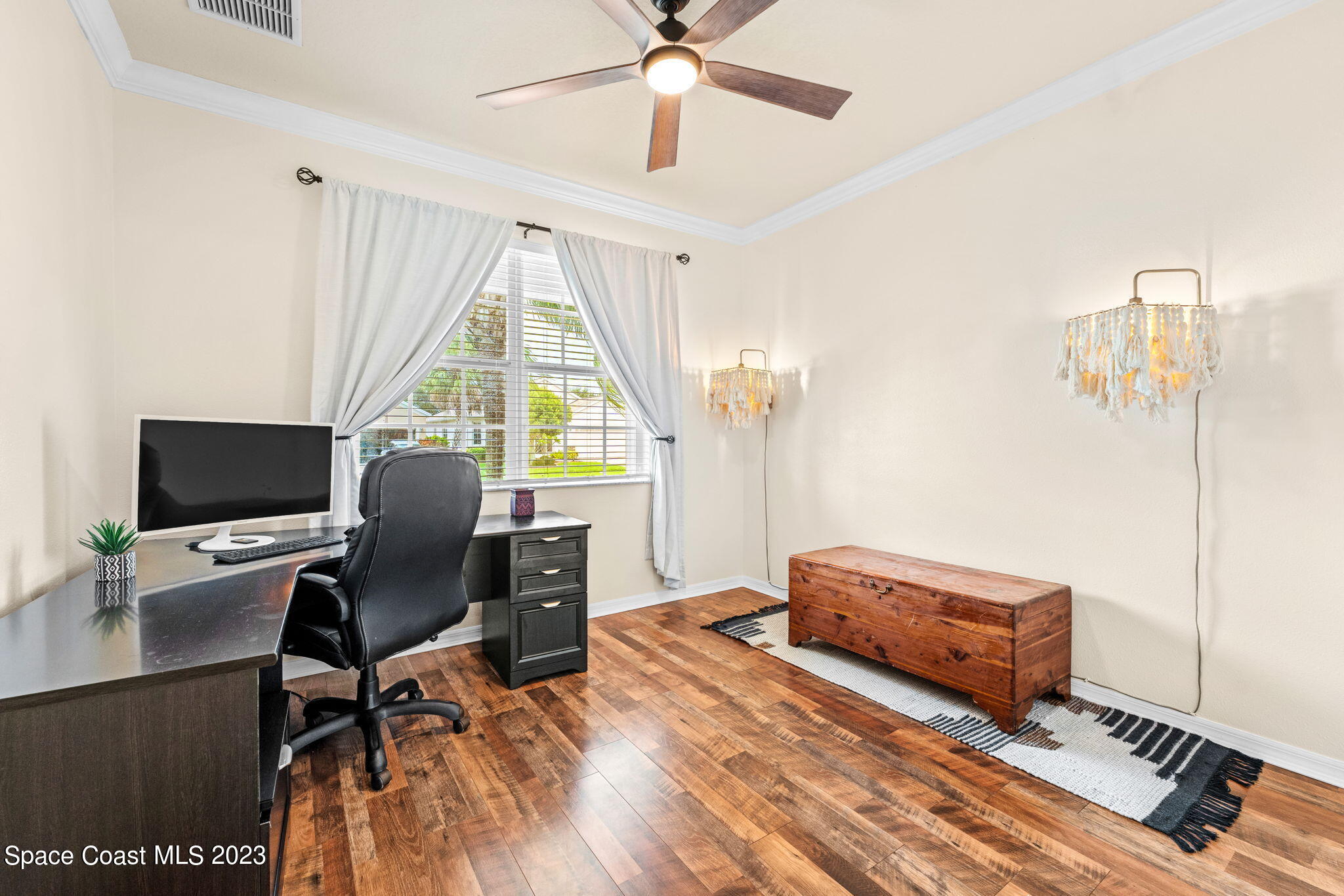 6265 Trieda Drive Melbourne, FL 32940 - Photo 16 of 26 a view of a workspace with furniture and a window