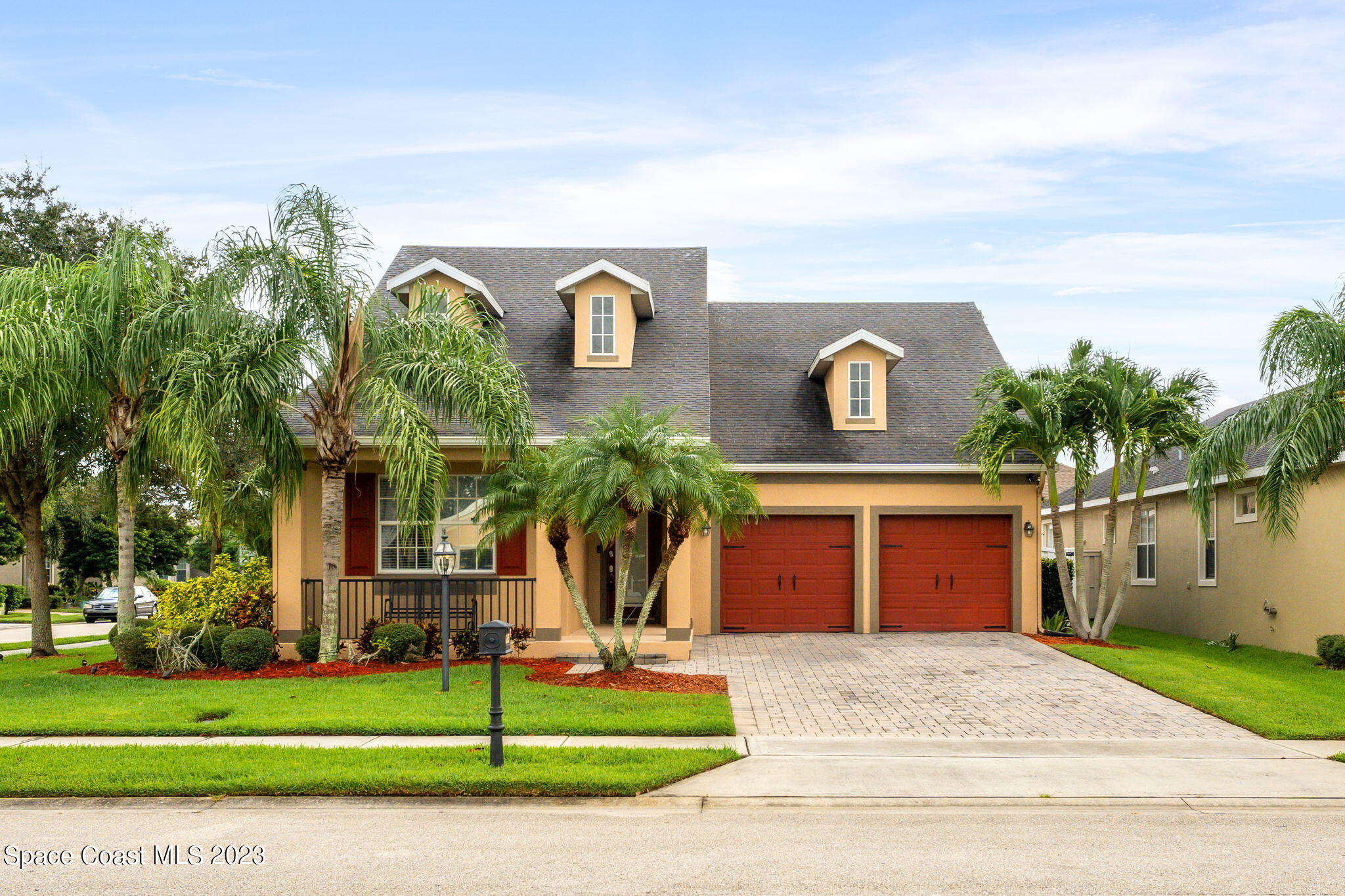 6265 Trieda Drive Melbourne, FL 32940 - Photo 26 of 26 a front view of a house with a yard and garage
