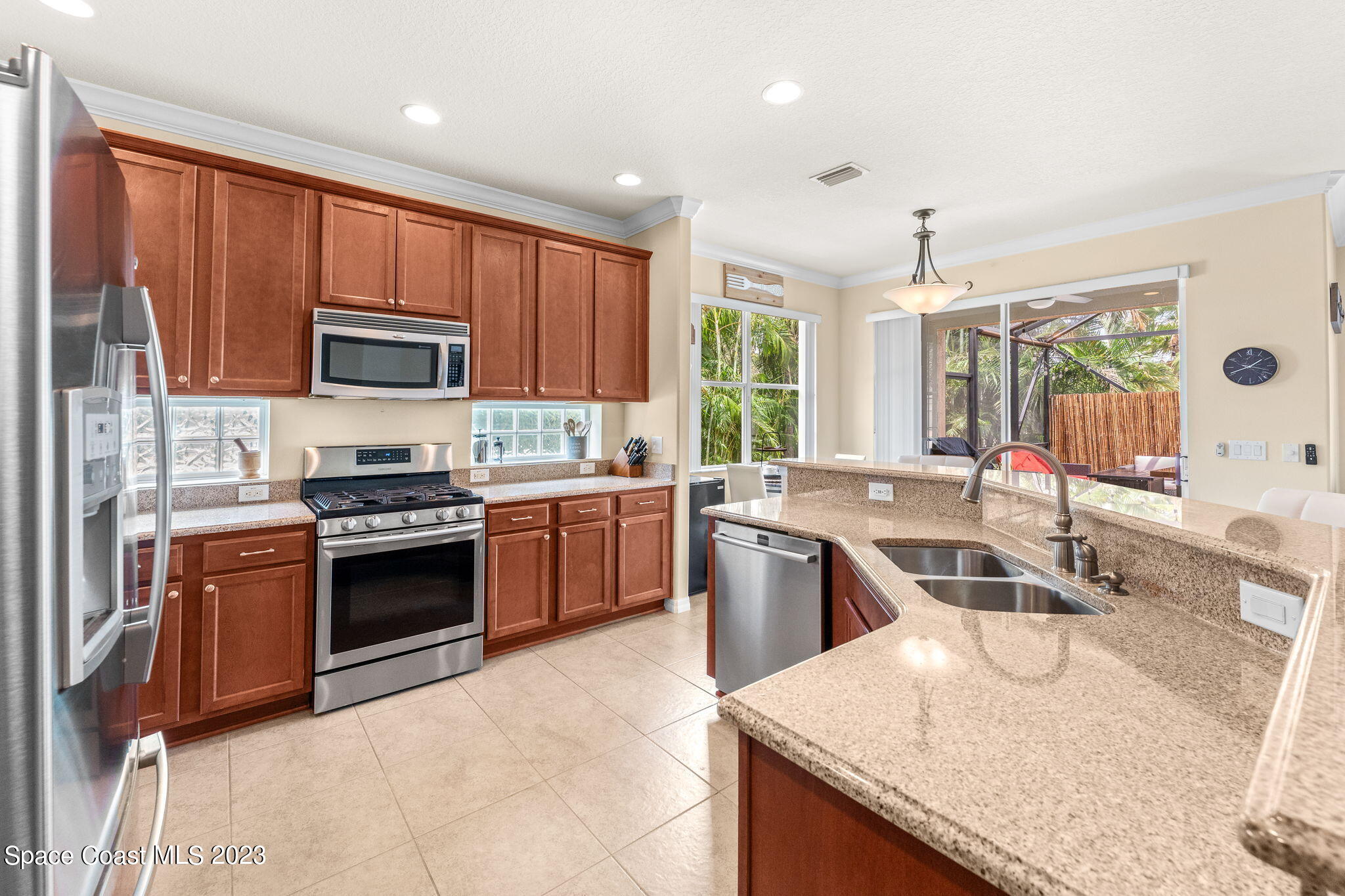 6265 Trieda Drive Melbourne, FL 32940 - Photo 5 of 26 a kitchen with stainless steel appliances granite countertop a sink stove and refrigerator