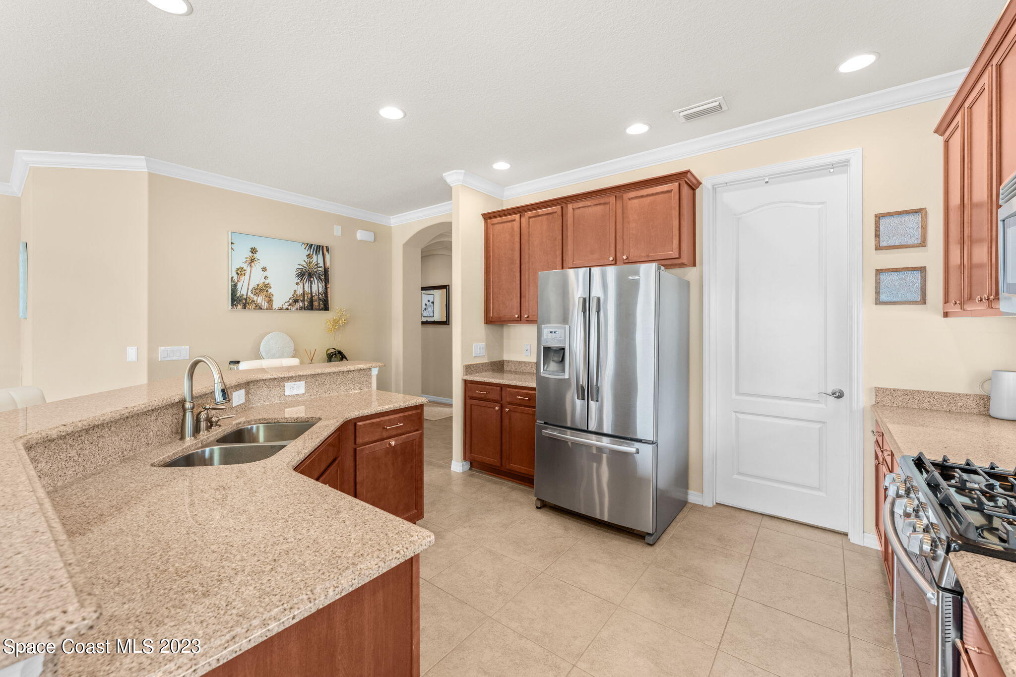 6265 Trieda Drive Melbourne, FL 32940 - Photo 7 of 26 a kitchen with stainless steel appliances granite countertop a refrigerator and a sink