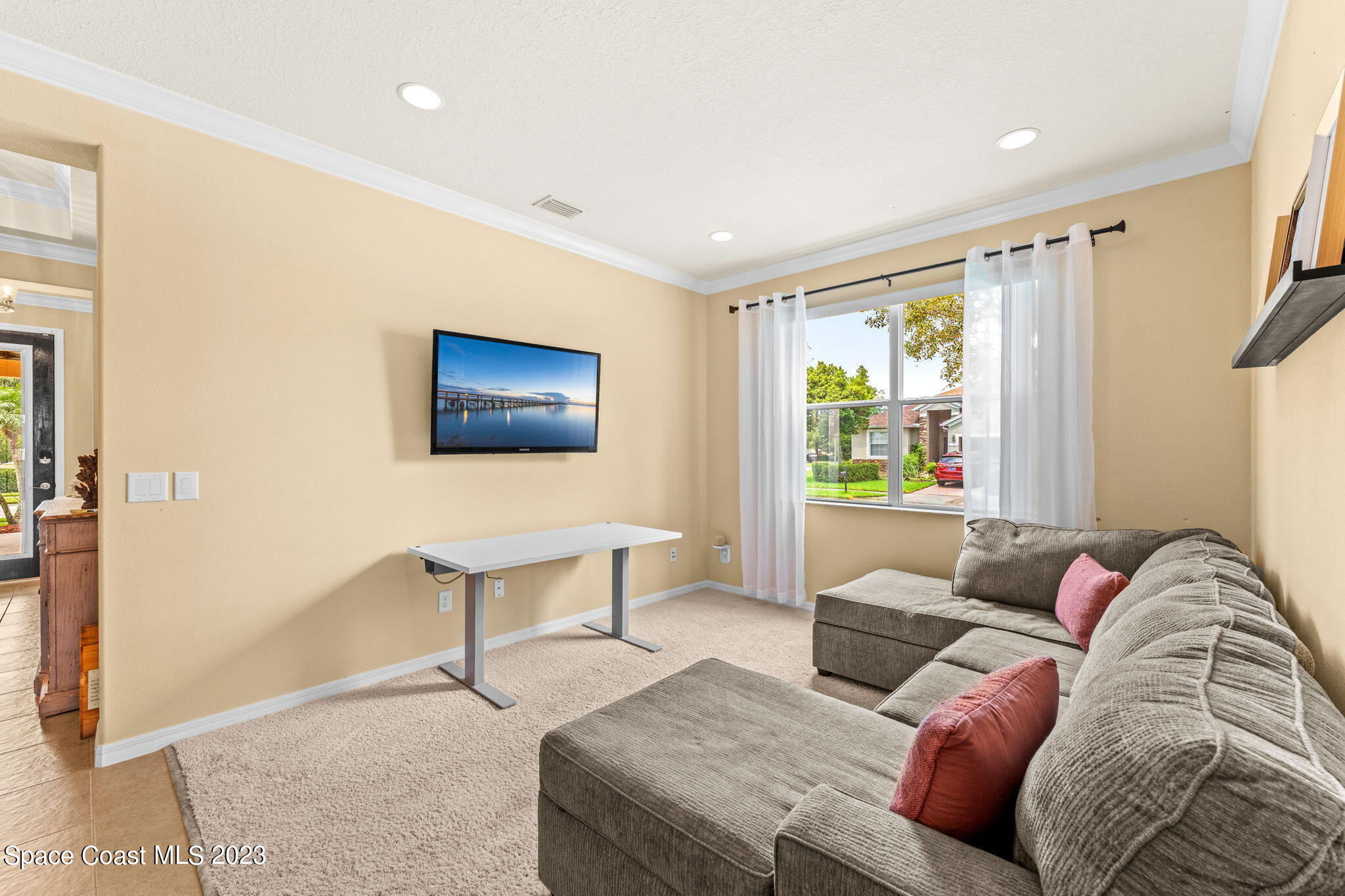 6265 Trieda Drive Melbourne, FL 32940 - Photo 8 of 26 a living room with furniture and a flat screen tv