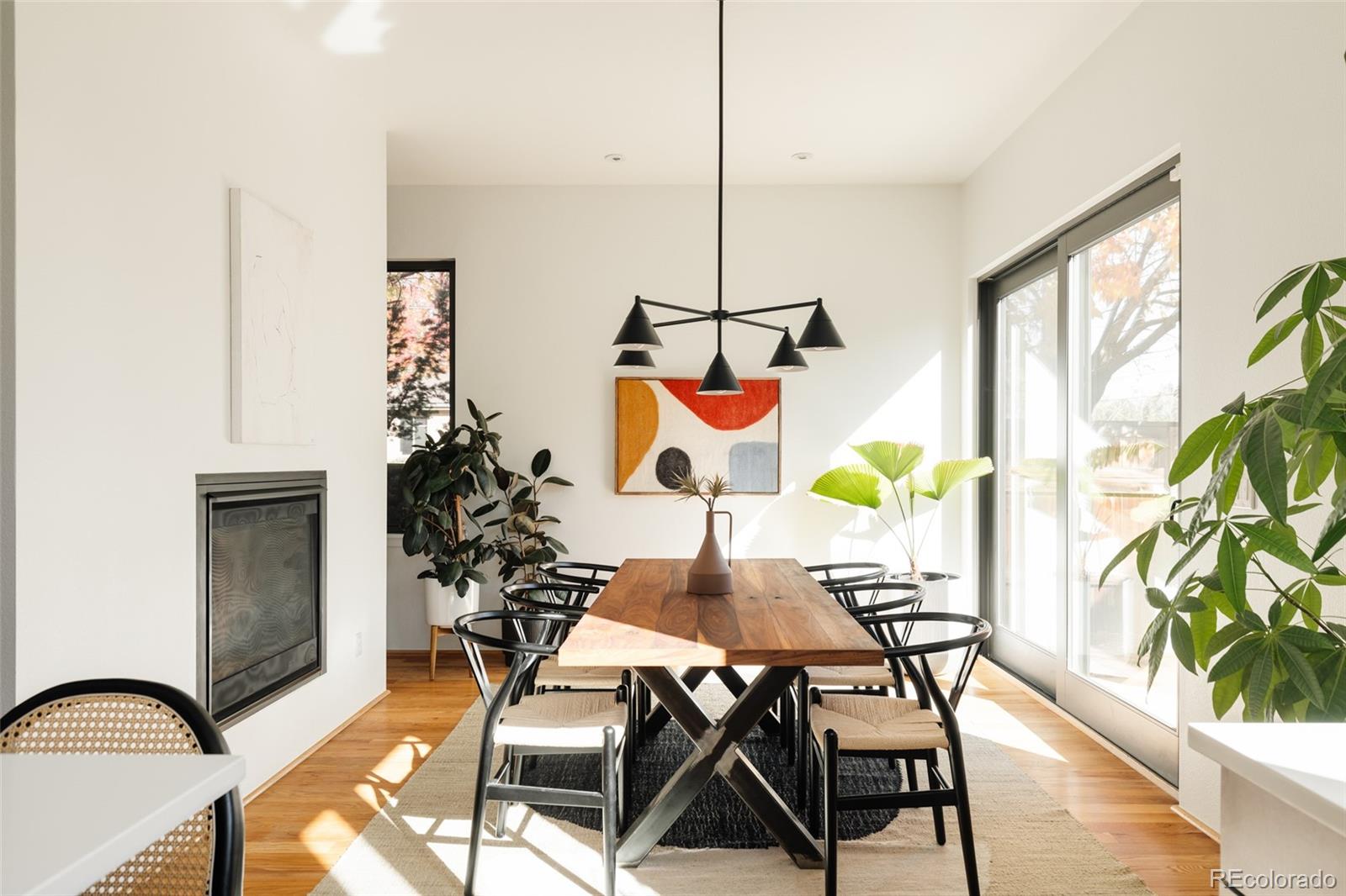 2696 Meade Street Denver, CO 80211 - Photo 13 of 46 a dining room filled chandelier and wooden floor