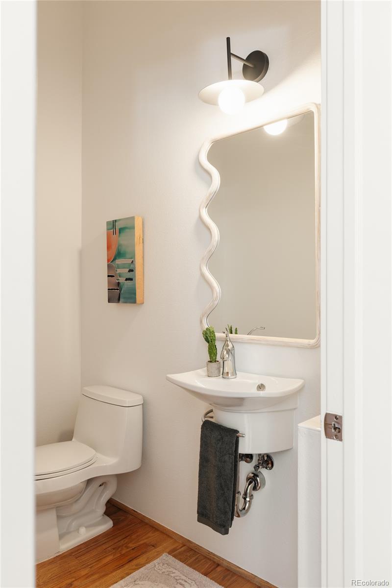 2696 Meade Street Denver, CO 80211 - Photo 17 of 46 a bathroom with a sink toilet and mirror