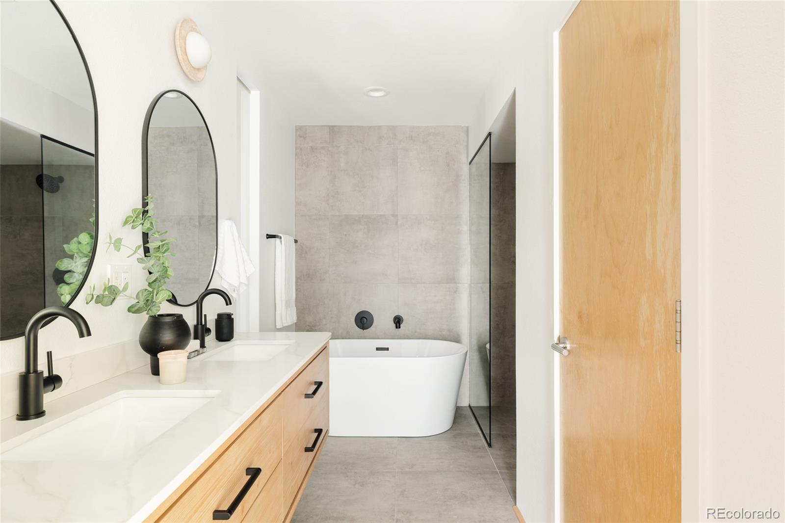 2696 Meade Street Denver, CO 80211 - Photo 24 of 46 a bathroom with a double vanity sink and mirror with shower