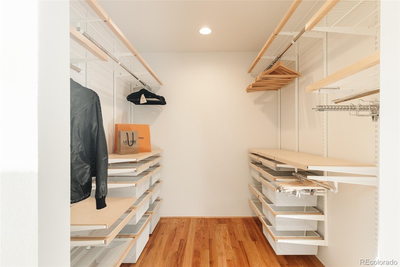 2696 Meade Street Denver, CO 80211 - Photo 26 of 46 a view of walk in closet with clothes and shoes