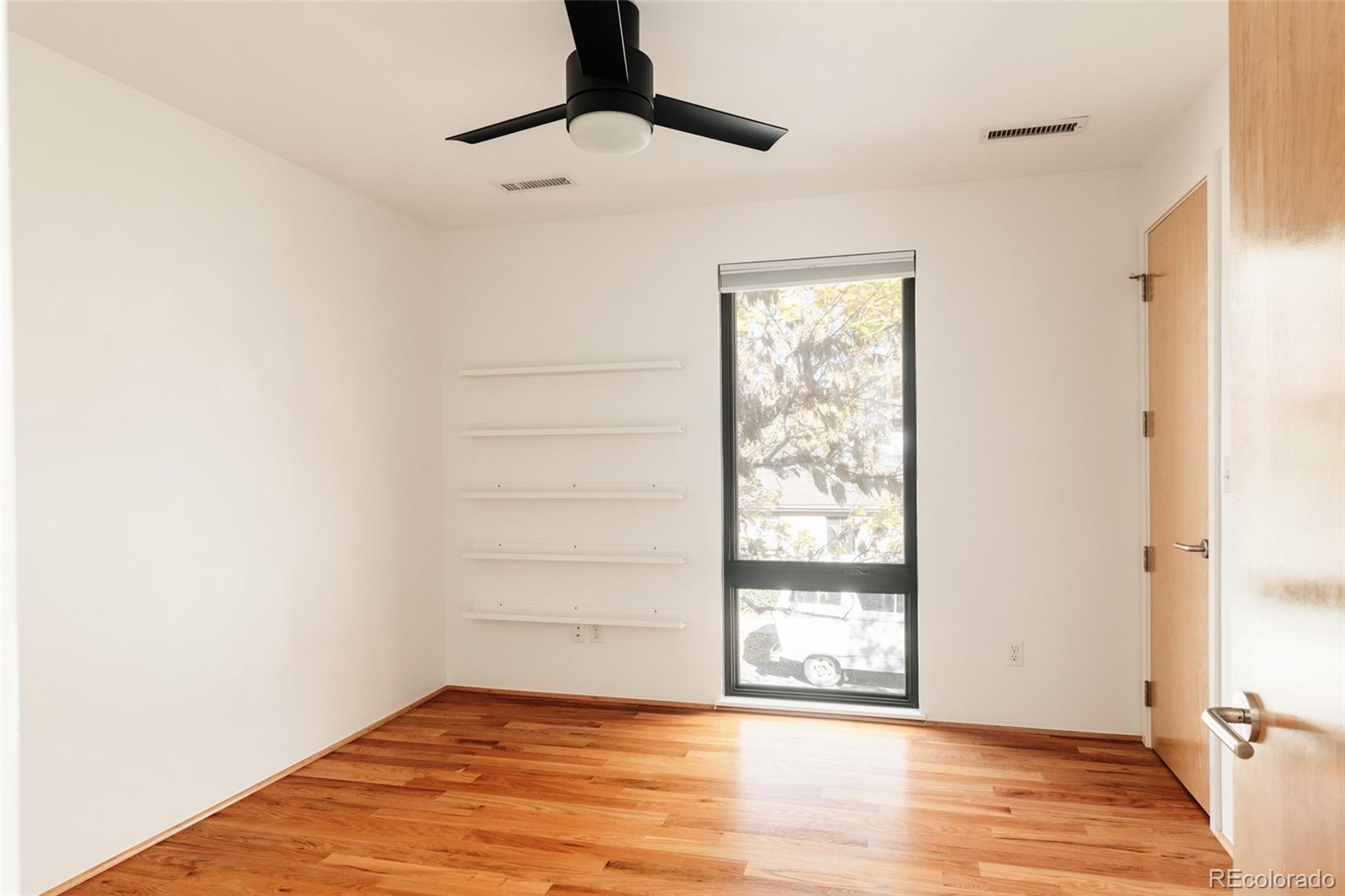 2696 Meade Street Denver, CO 80211 - Photo 27 of 46 a view of an empty room with wooden floor and a window