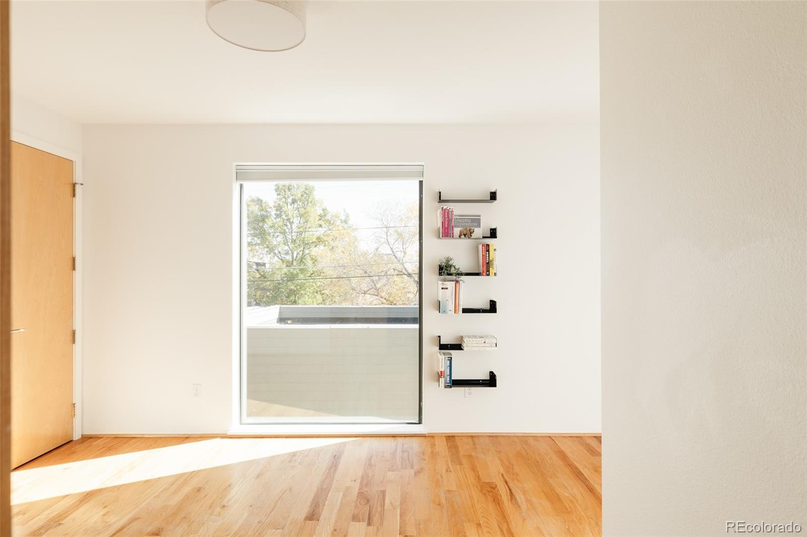 2696 Meade Street Denver, CO 80211 - Photo 28 of 46 a view of a room with wooden floor and windows