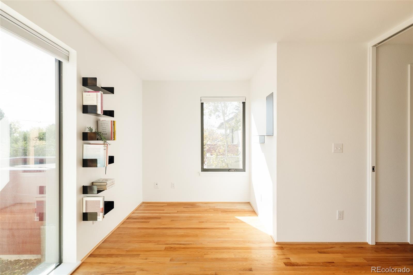 2696 Meade Street Denver, CO 80211 - Photo 29 of 46 a view of a bedroom with wooden floor and windows