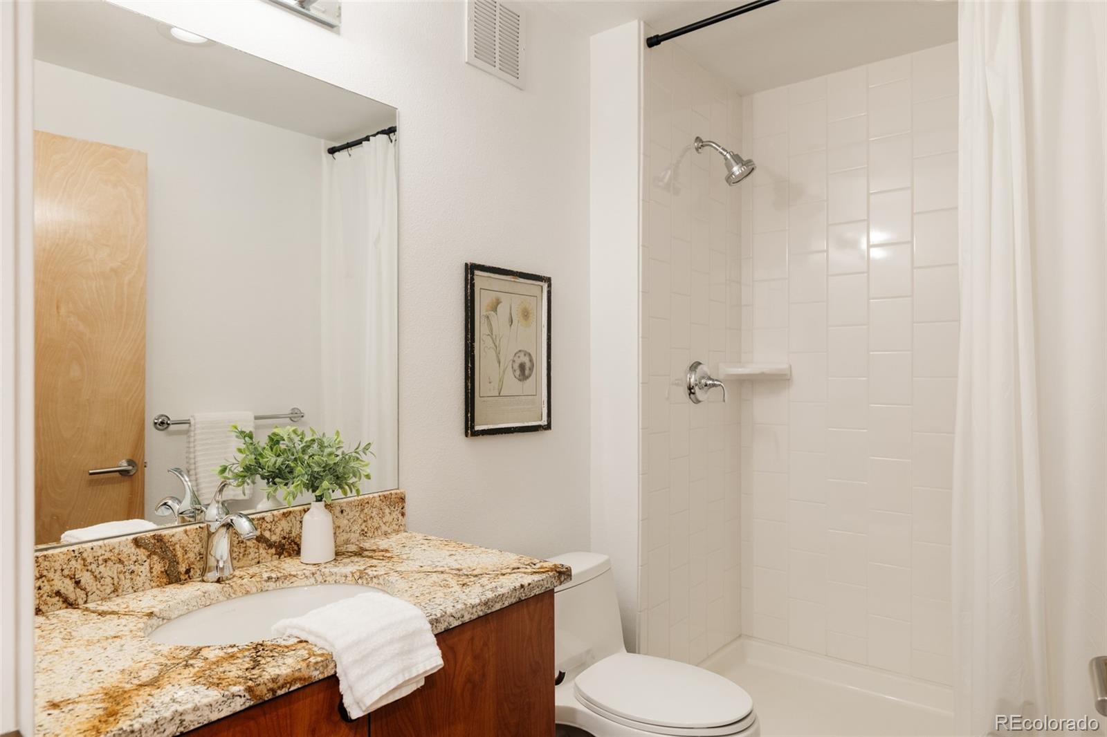 2696 Meade Street Denver, CO 80211 - Photo 39 of 46 a bathroom with a granite countertop sink toilet and shower