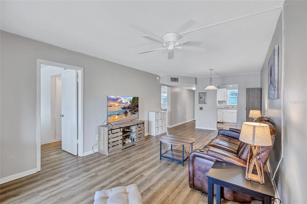 3125 36th Street North, Unit 208 St. Petersburg, FL 33713 - Photo 11 of 29 a living room with furniture and a flat screen tv