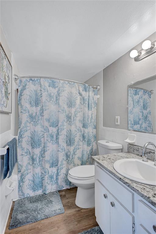 3125 36th Street North, Unit 208 St. Petersburg, FL 33713 - Photo 15 of 29 a bathroom with a granite countertop sink a toilet and a shower