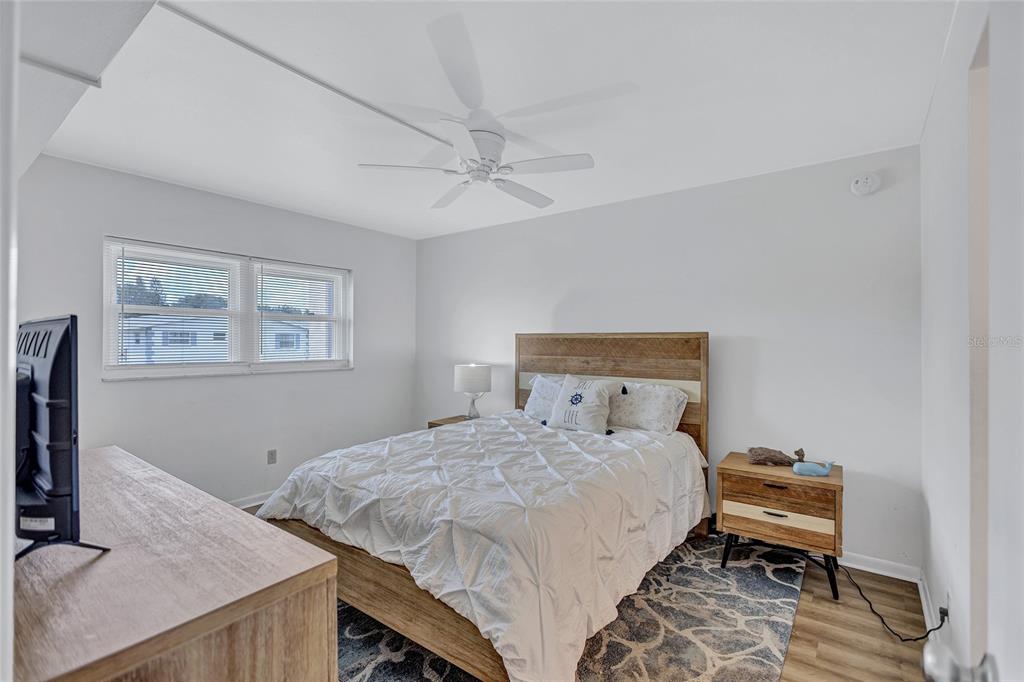 3125 36th Street North, Unit 208 St. Petersburg, FL 33713 - Photo 16 of 29 a bedroom with a bed and a desk