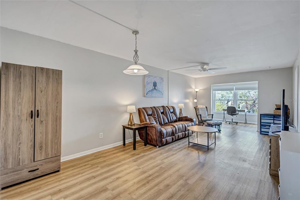 3125 36th Street North, Unit 208 St. Petersburg, FL 33713 - Photo 6 of 29 a living room with furniture and wooden floor