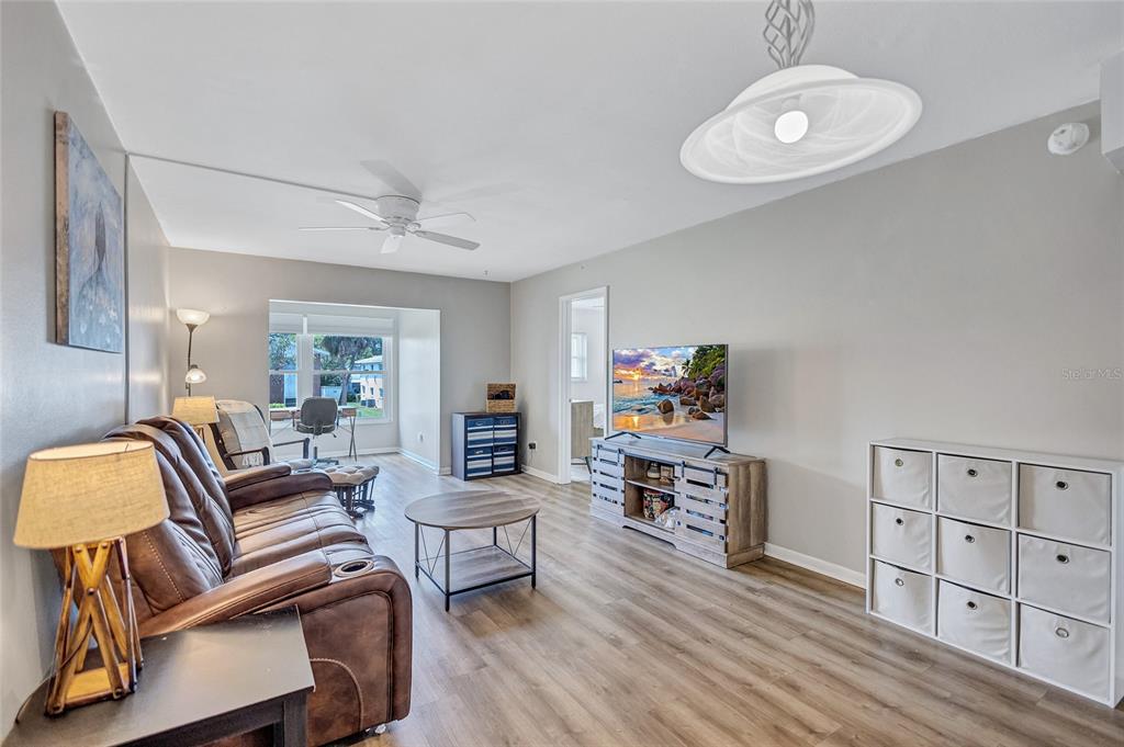 3125 36th Street North, Unit 208 St. Petersburg, FL 33713 - Photo 8 of 29 a living room with furniture and a wooden floor