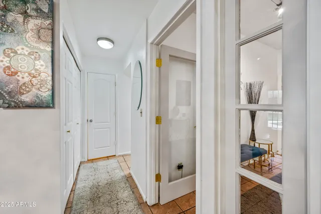 a kitchen with white cabinets and refrigerator