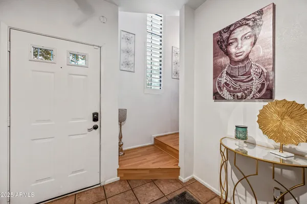 a bedroom with a bed and a flat tv screen on dresser