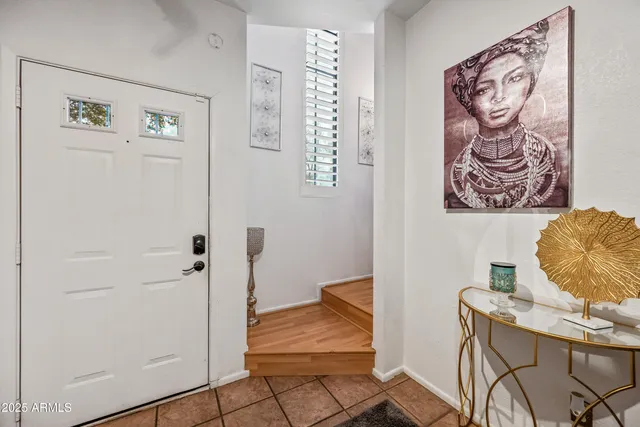 a bedroom with a bed and a flat tv screen on dresser