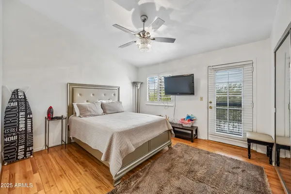 a bedroom with a large bed and a chandelier