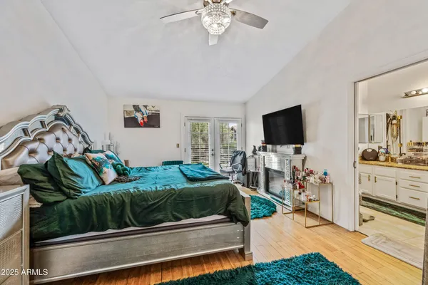 a bathroom with a granite countertop double vanity sink a mirror and a shower