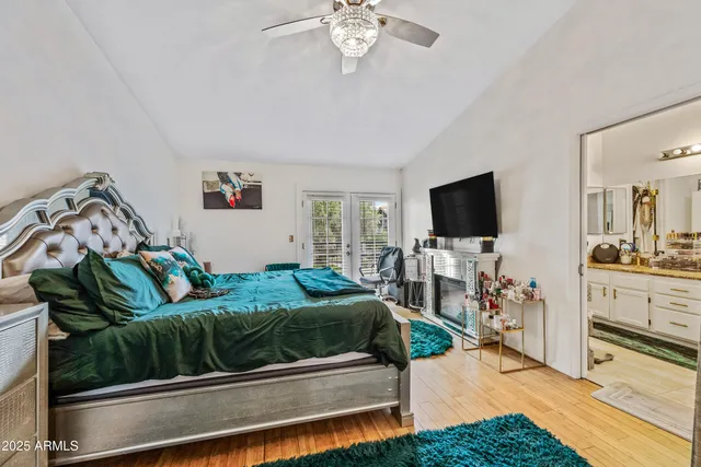 a bathroom with a granite countertop double vanity sink a mirror and a shower
