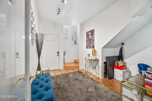 a living room with furniture and a baby crib