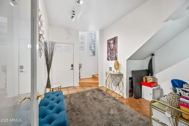 a living room with furniture and a baby crib