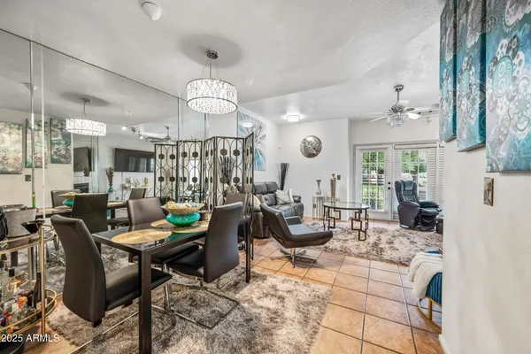 a living room with fireplace furniture and a chandelier
