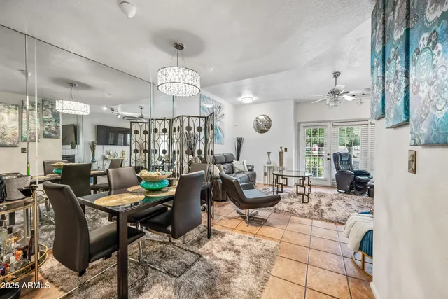 a living room with fireplace furniture and a chandelier