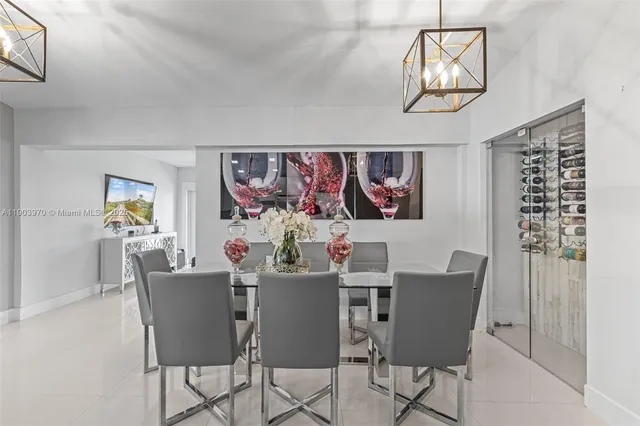 a view of a dining room with furniture a chandelier and wooden floor
