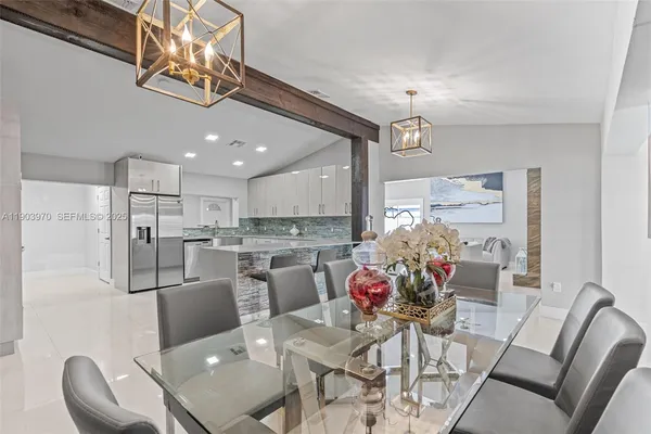 a view of a dining room with furniture kitchen and chandelier