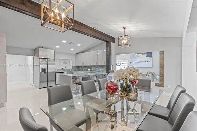 a view of a dining room with furniture kitchen and chandelier