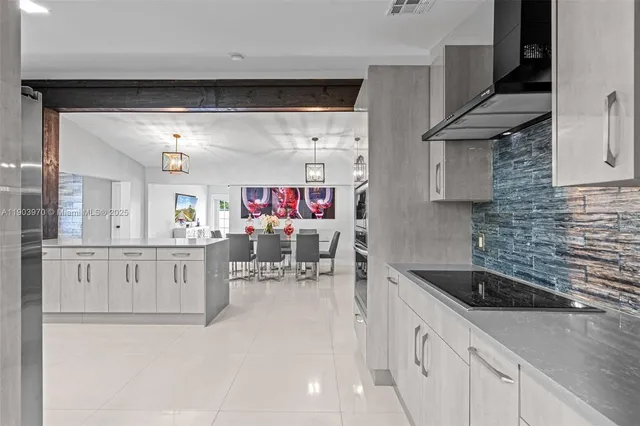 a kitchen with granite countertop a sink a stove and cabinets