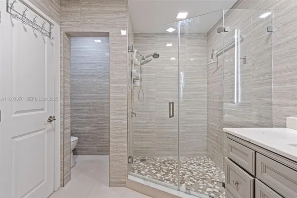 a bathroom with a shower and a sink