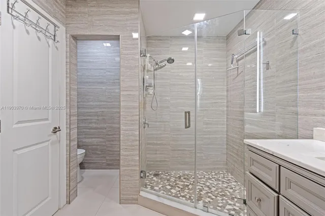 a bathroom with a shower and a sink