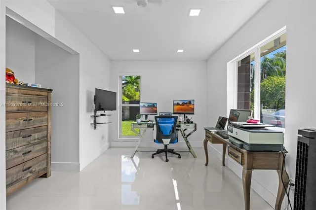 a view of a workspace with furniture and a window