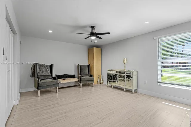 a living room with furniture and a ceiling fan