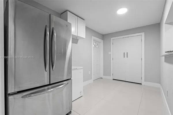 an empty room with wooden floor and window